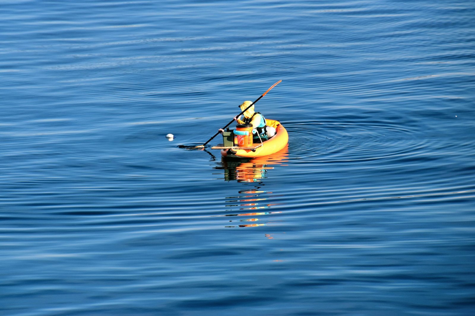A man in a kayak in the middle of a body of water